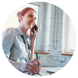 woman sitting at desk and talking on the phone