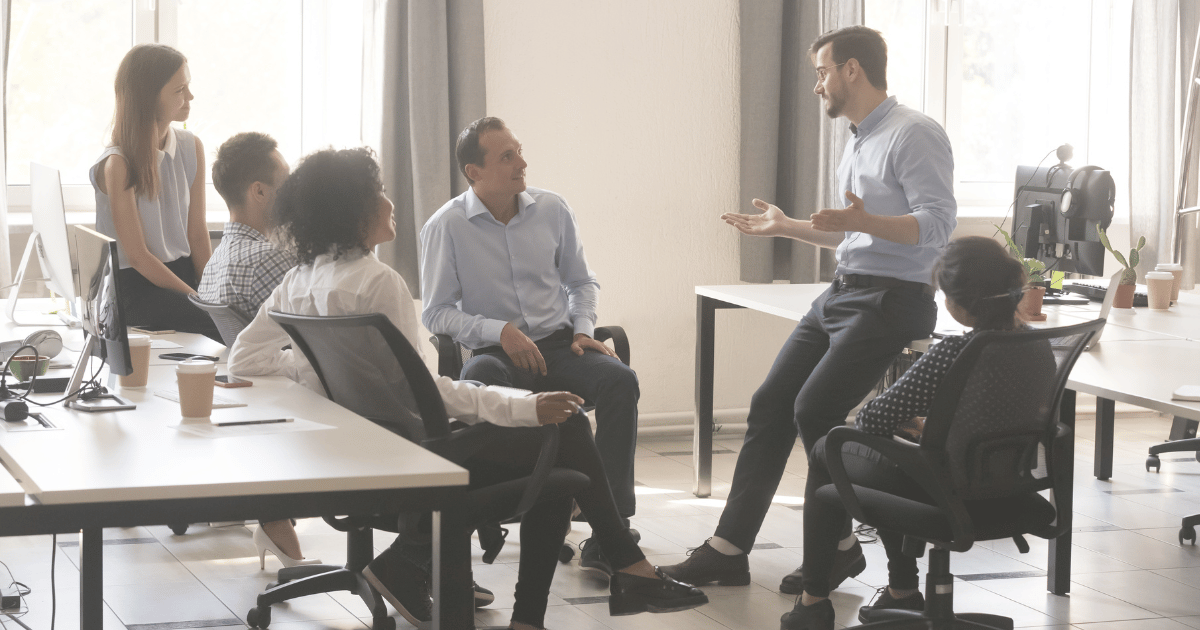 group of people talking in an office