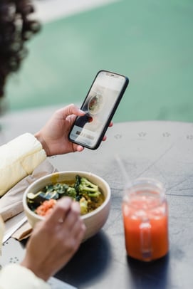 Social Media Influencer takes a picture of her meal for a brand collaboration